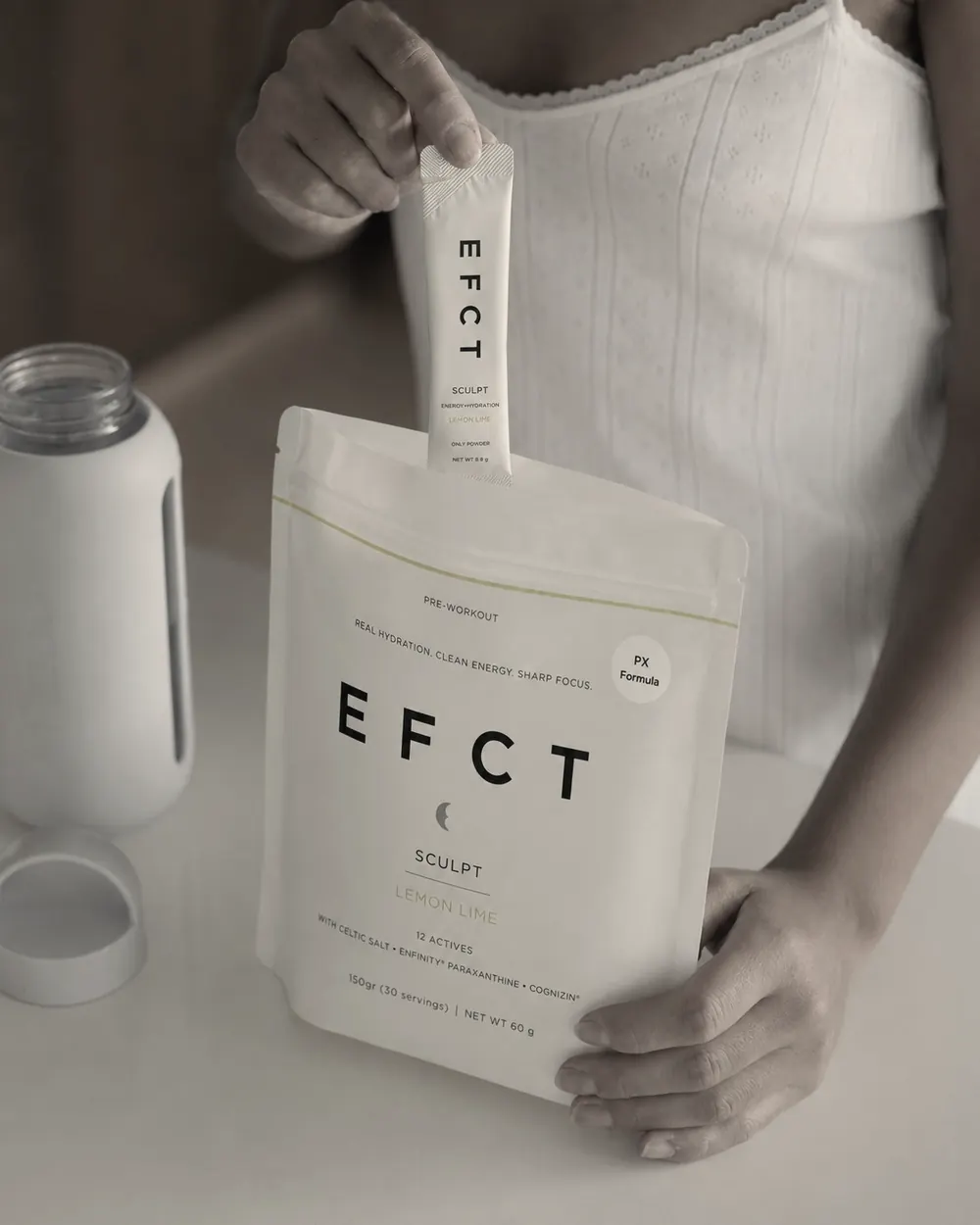 A woman taking a stick pack out of the EFCT pouch
